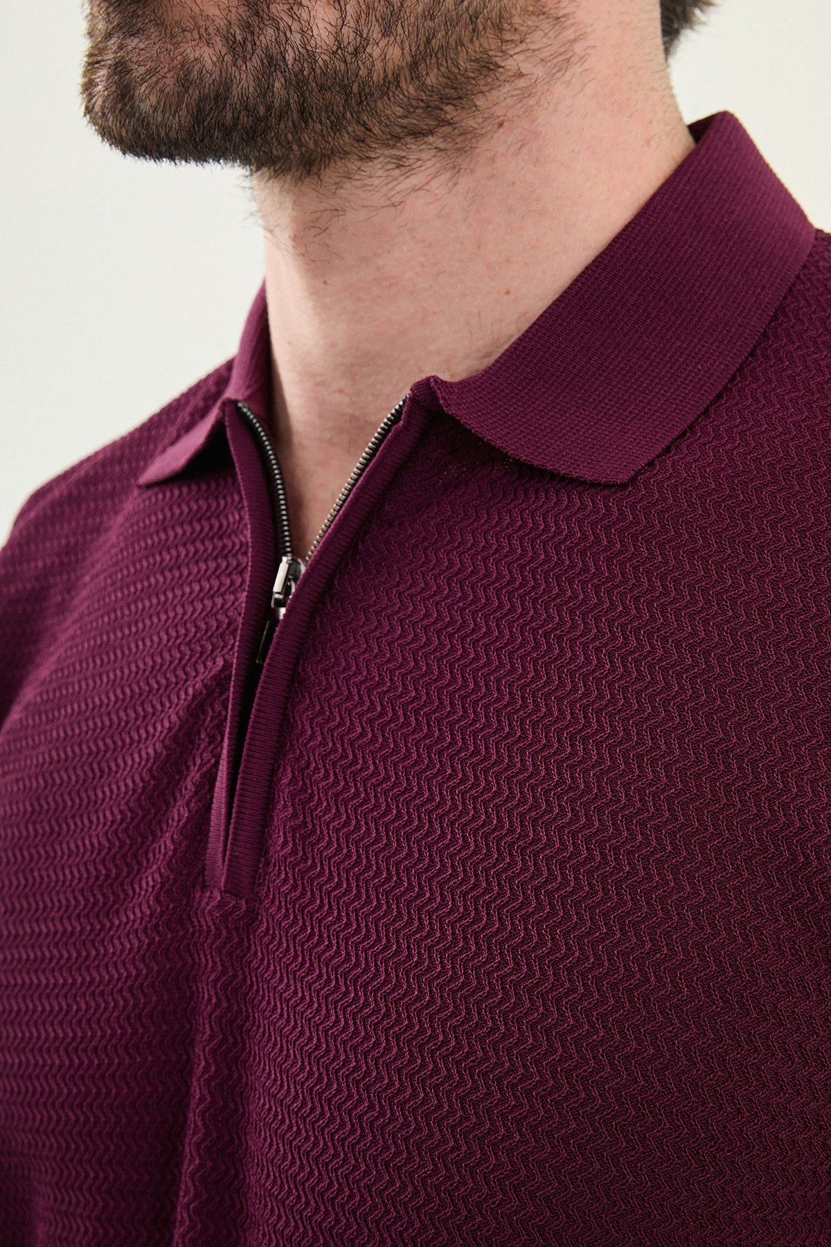 Men wearing a burgundy slim-fit quarter-zip polo T-shirt with short sleeves, styled for a modern summer casual outfit.