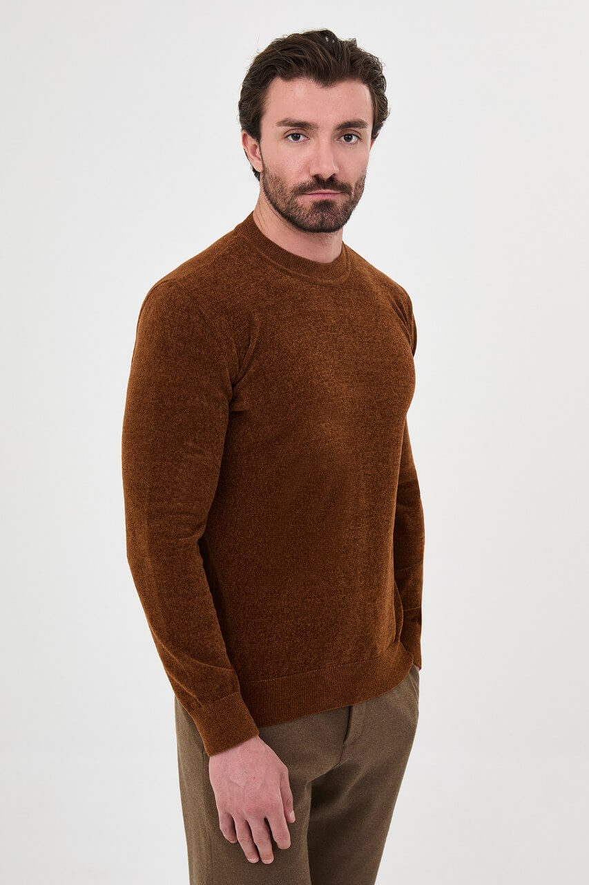 Men’s camel crew neck knit sweater in a cotton blend slim fit design styled with brown trousers for a refined fall winter outfit.