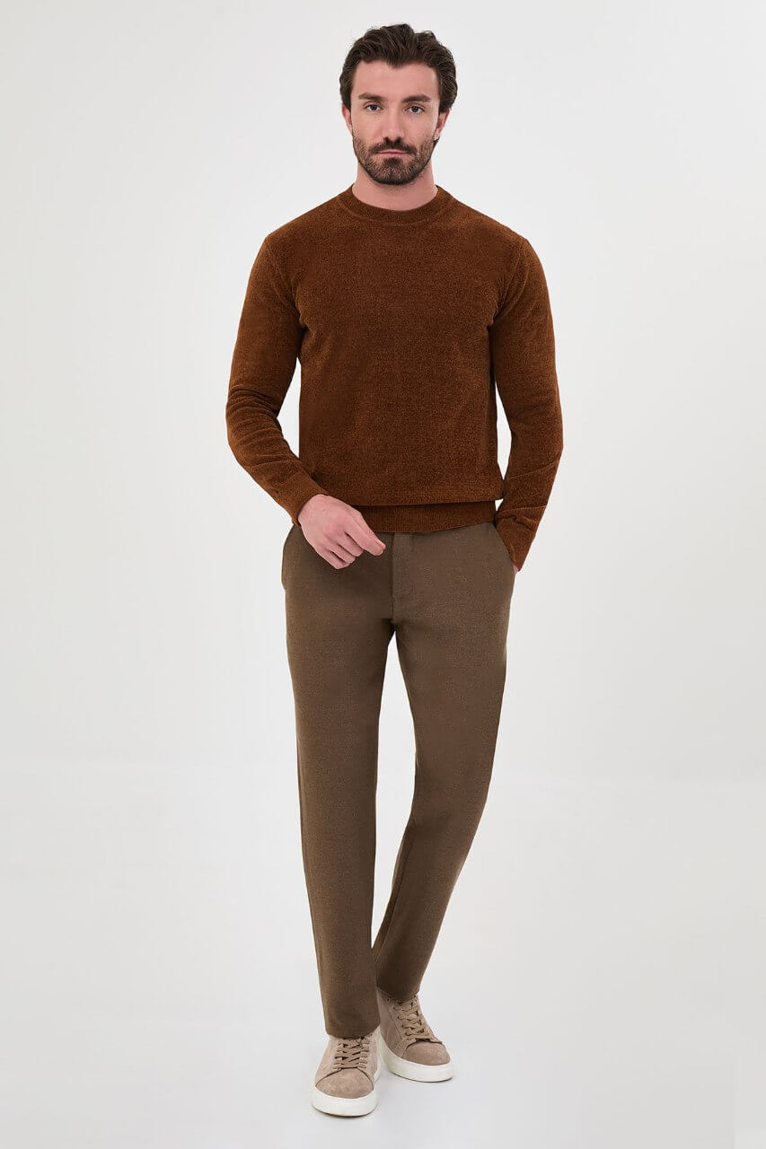 Men’s camel crew neck knit sweater in a cotton blend slim fit design styled with brown trousers for a refined fall winter outfit.