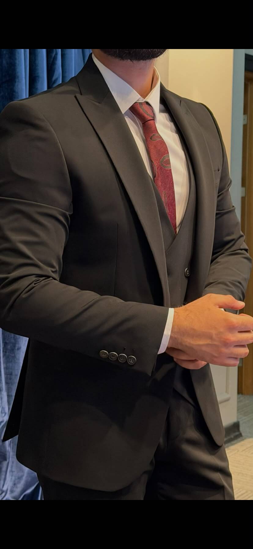 Men’s black three piece suit with tailored jacket, matching waistcoat, notch lapels, and formal trousers for weddings, business events, and elegant occasions.