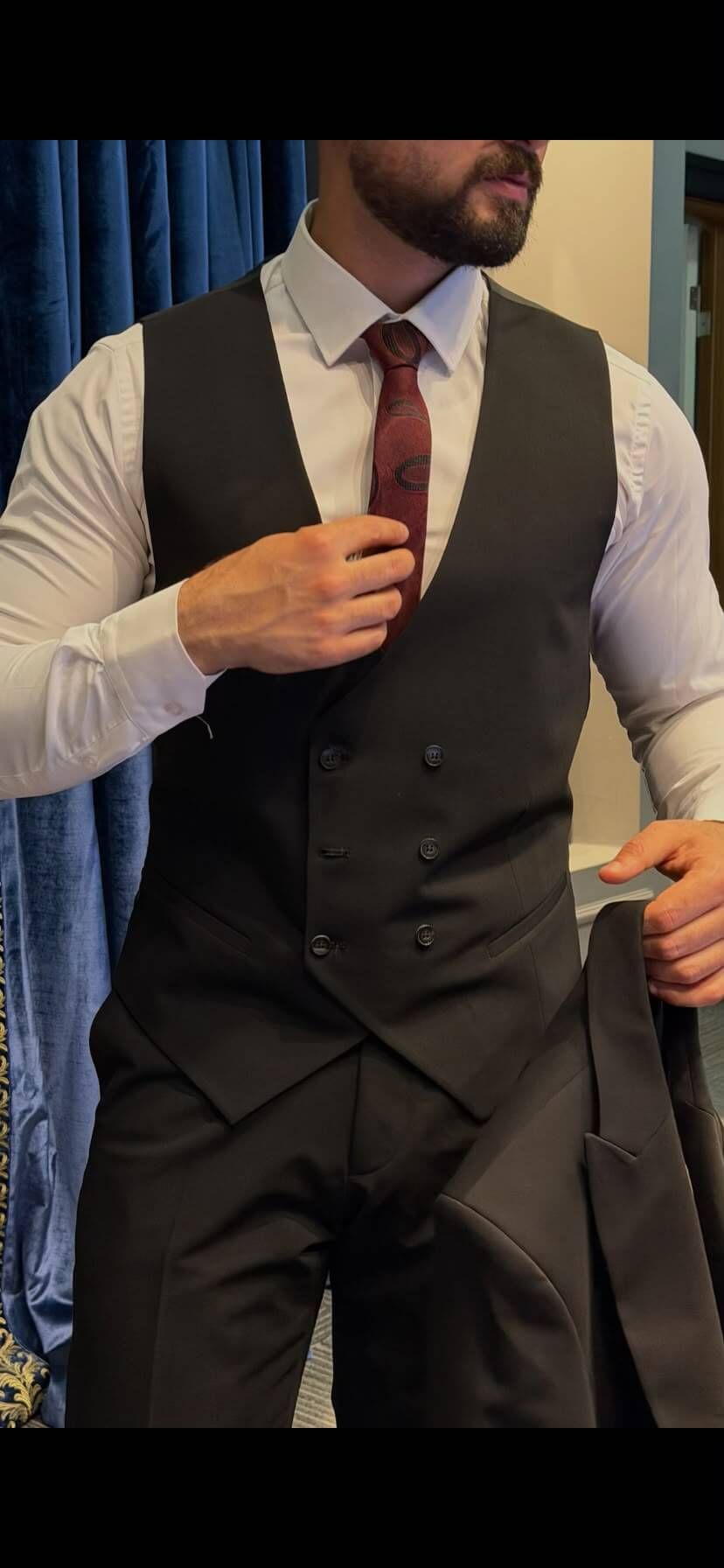 Men’s black three piece suit with tailored jacket, matching waistcoat, notch lapels, and formal trousers for weddings, business events, and elegant occasions.