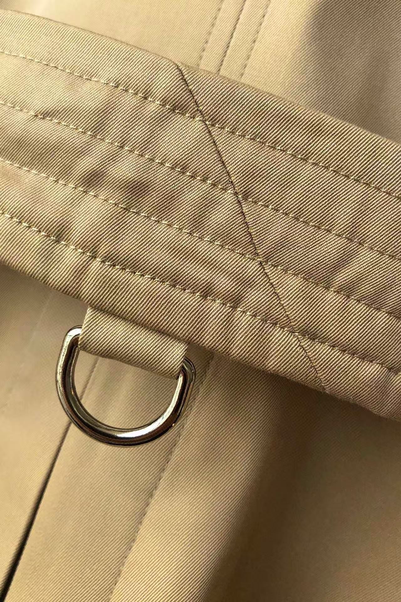 men’s beige double-breasted trench coat with belt and epaulets on hanger