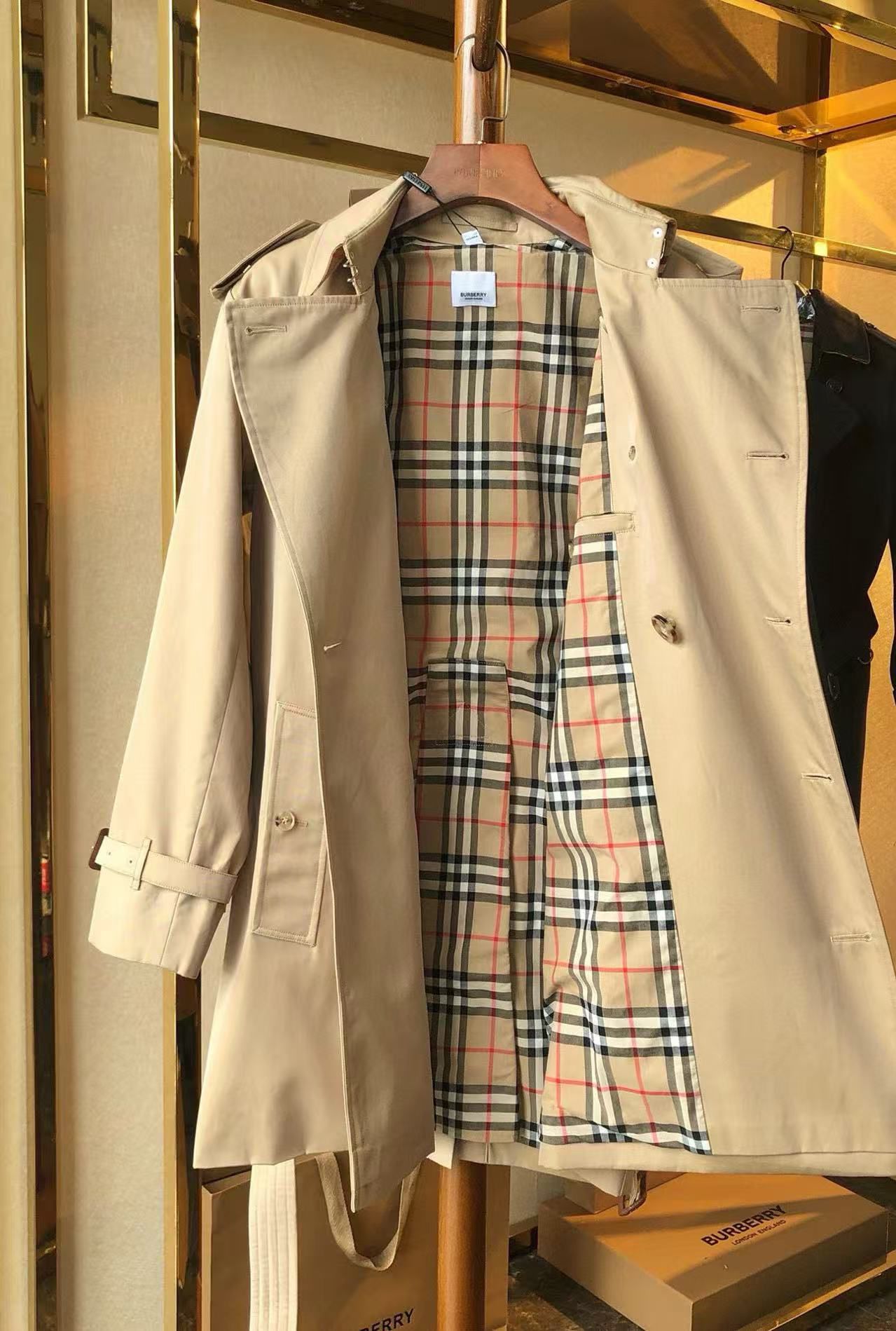 men’s beige double-breasted trench coat with belt and epaulets on hanger