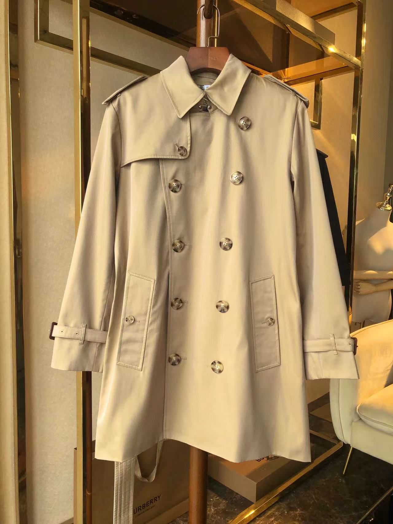 men’s beige double-breasted trench coat with belt and epaulets on hanger