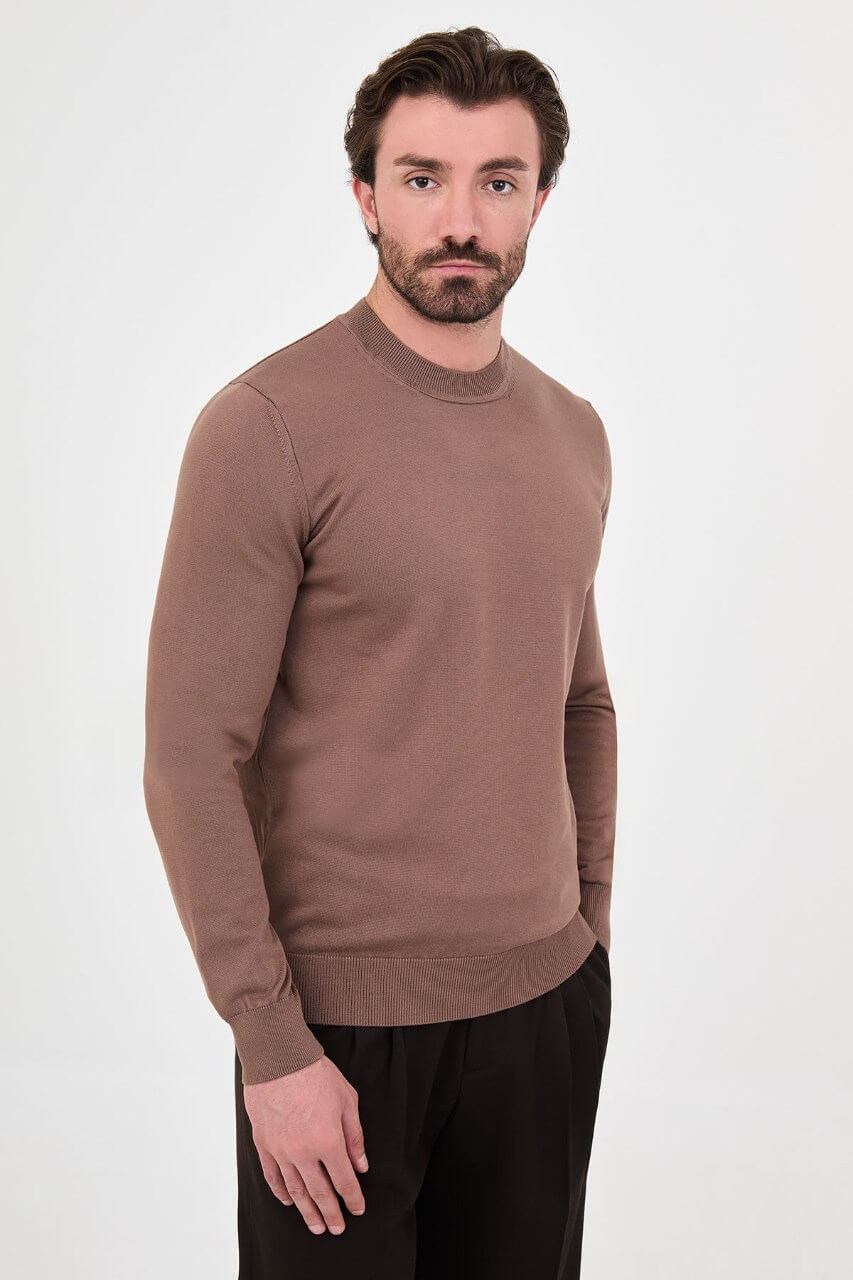 Men’s light brown cotton crewneck knit sweater styled with black trousers for fall winter fashion