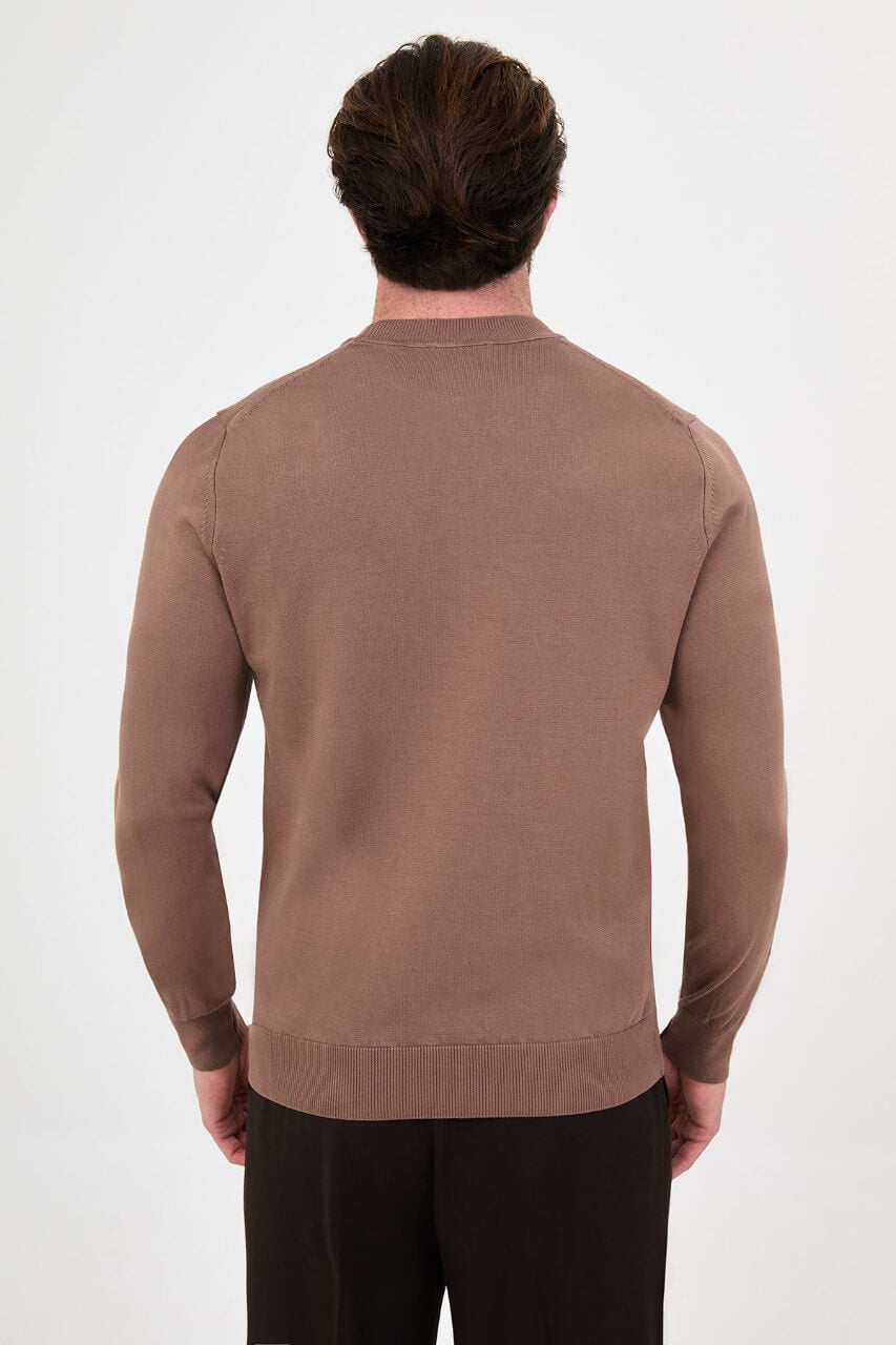 Men’s light brown cotton crewneck knit sweater styled with black trousers for fall winter fashion