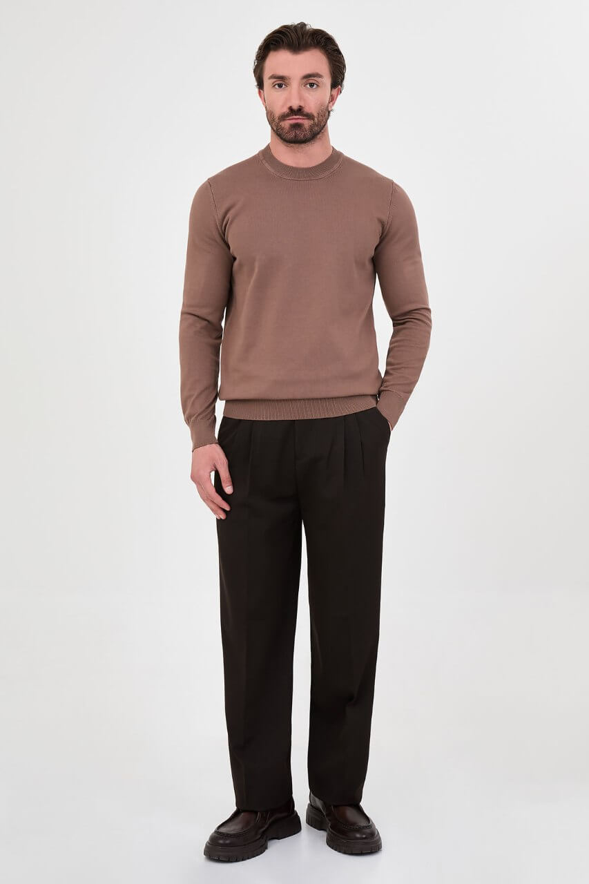 Men’s light brown cotton crewneck knit sweater styled with black trousers for fall winter fashion