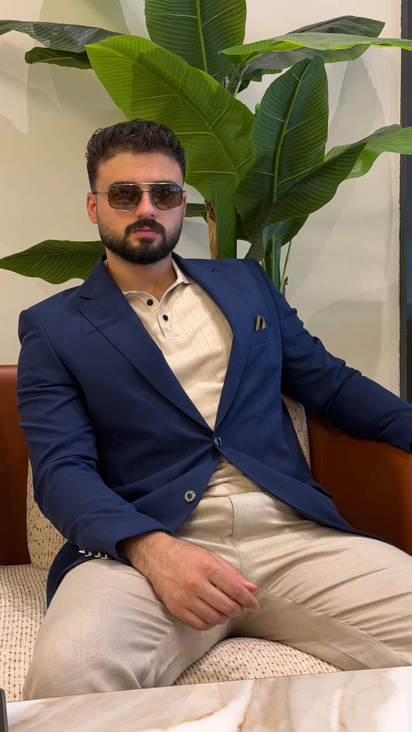 Men’s navy blue wool blend blazer styled with cream polo shirt and tailored trousers