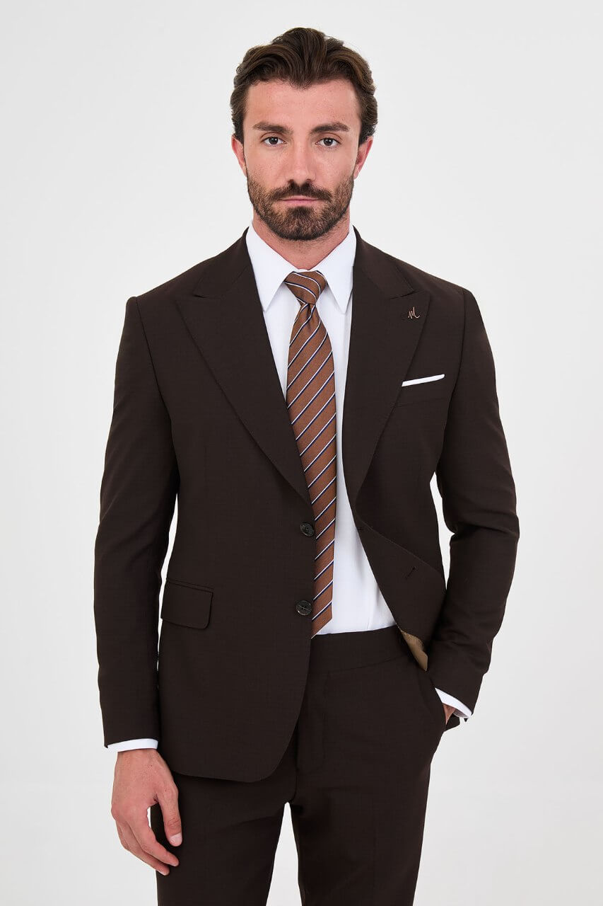 Men's brown slim-fit two-piece suit with a tailored blazer, notch lapels and matching trousers.