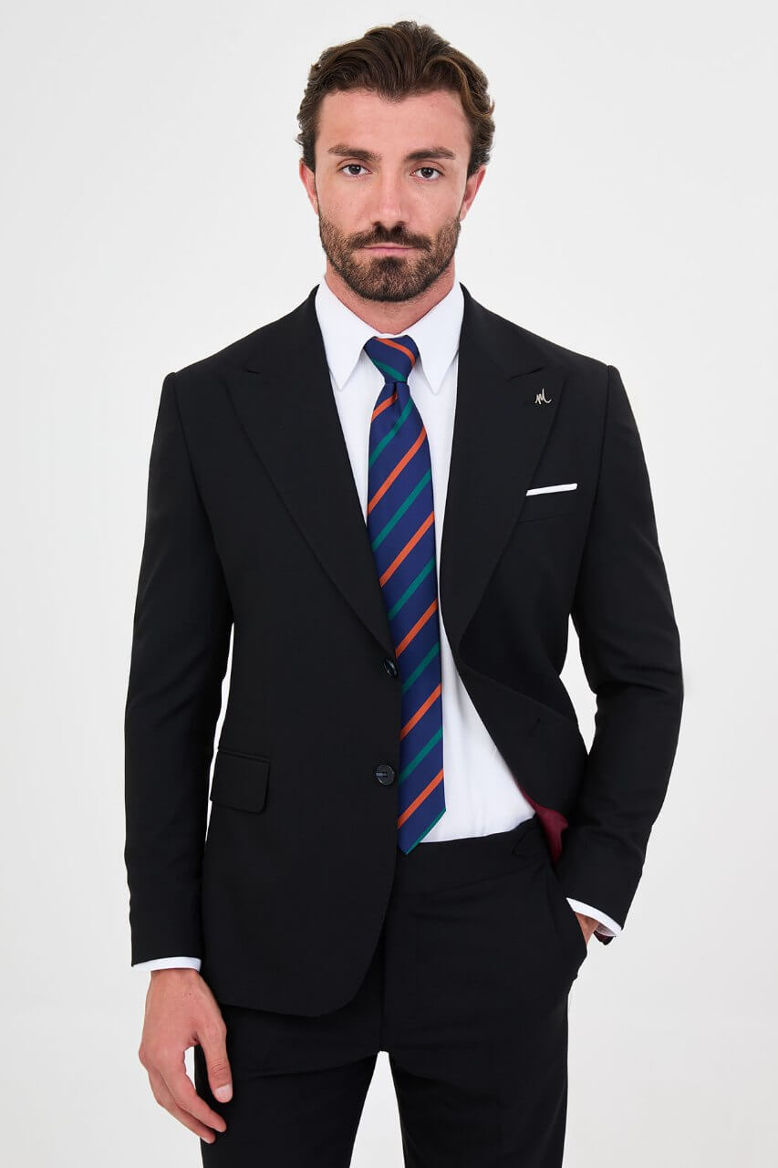 Men's navy blue slim-fit two-piece business suit featuring a tailored blazer, notch lapels and flap pockets.