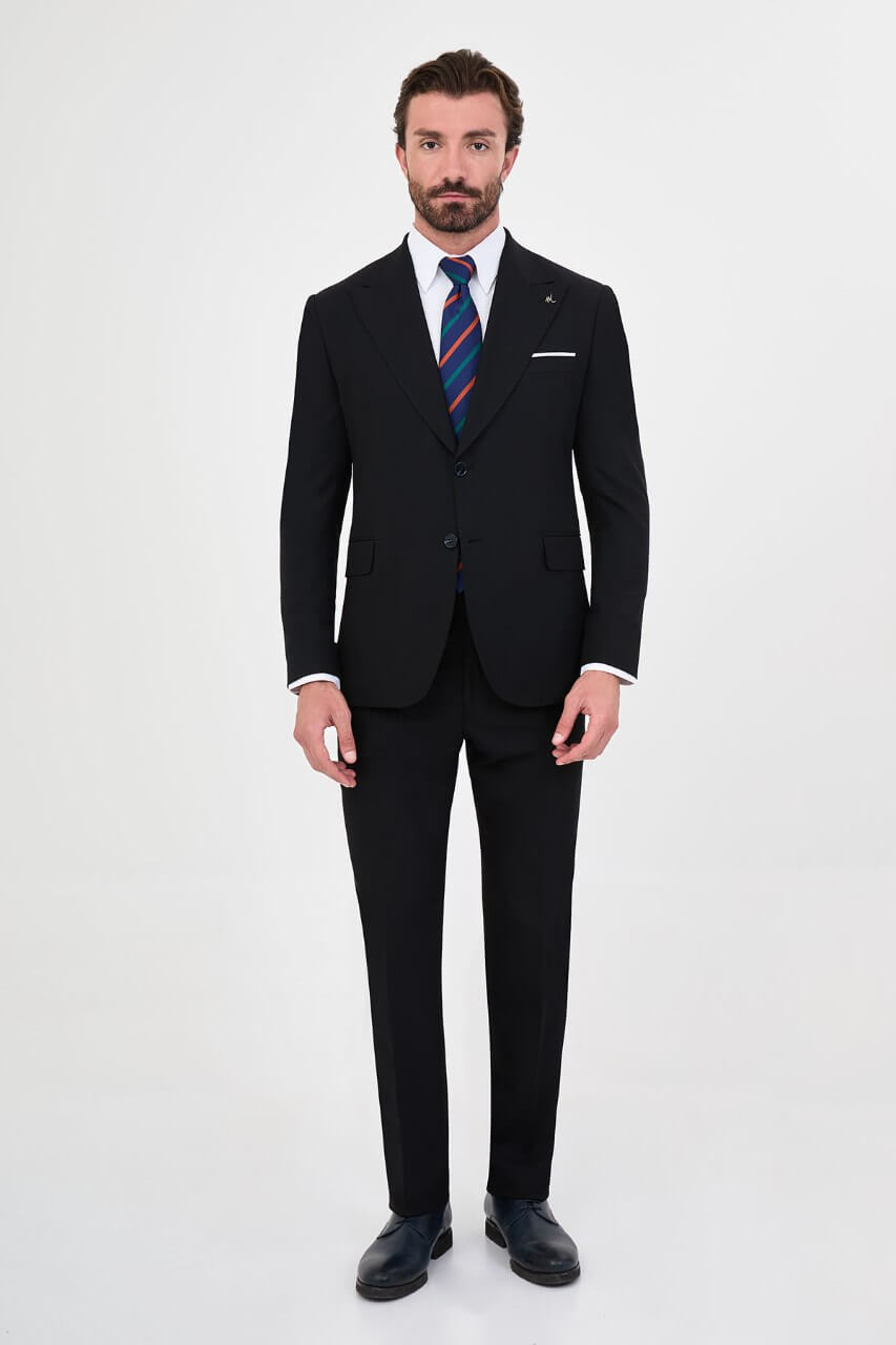 Men's navy blue slim-fit two-piece business suit featuring a tailored blazer, notch lapels and flap pockets.