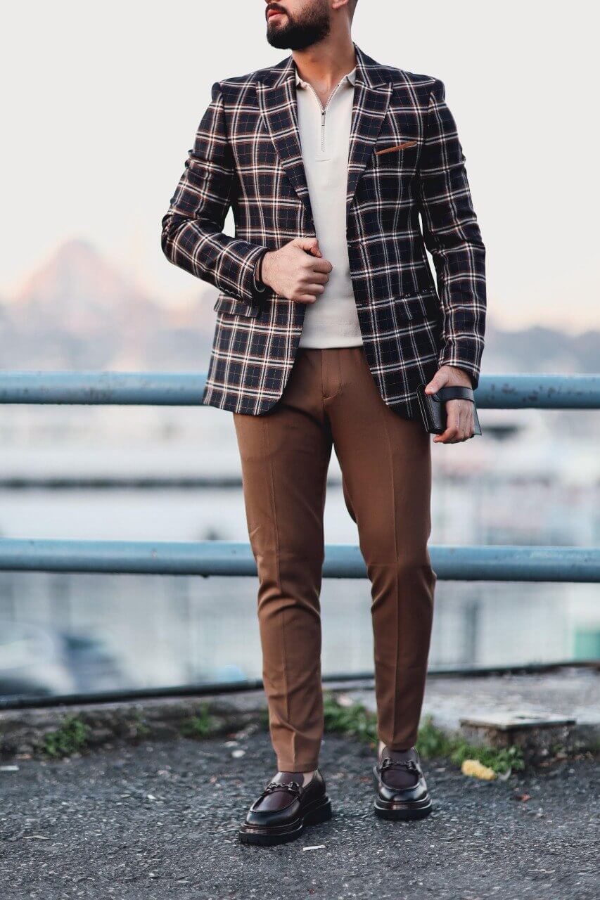 Men’s dark blue plaid mono-collar slim-fit jacket styled with beige knit top and brown trousers