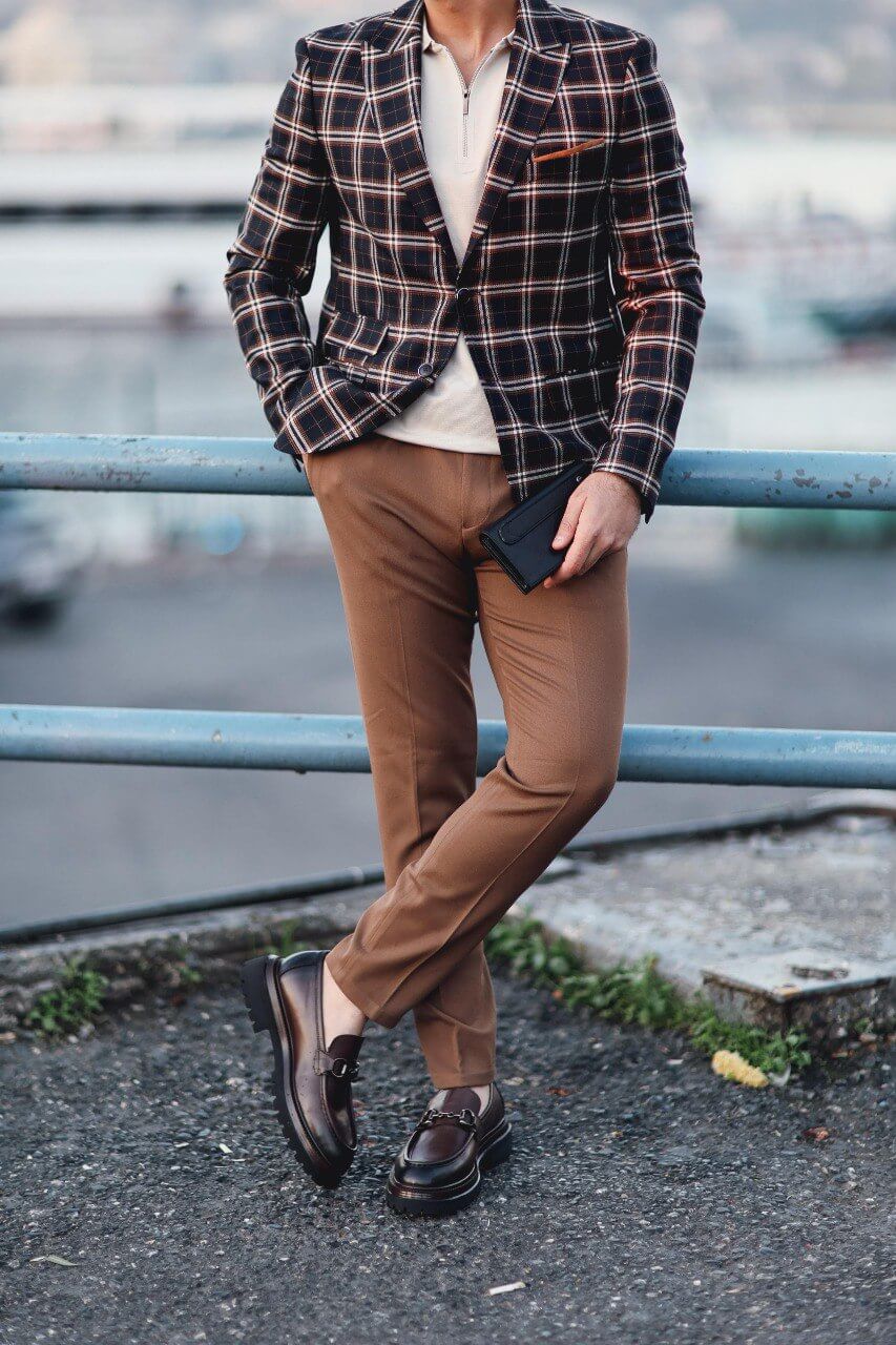 Men’s dark blue plaid mono-collar slim-fit jacket styled with beige knit top and brown trousers