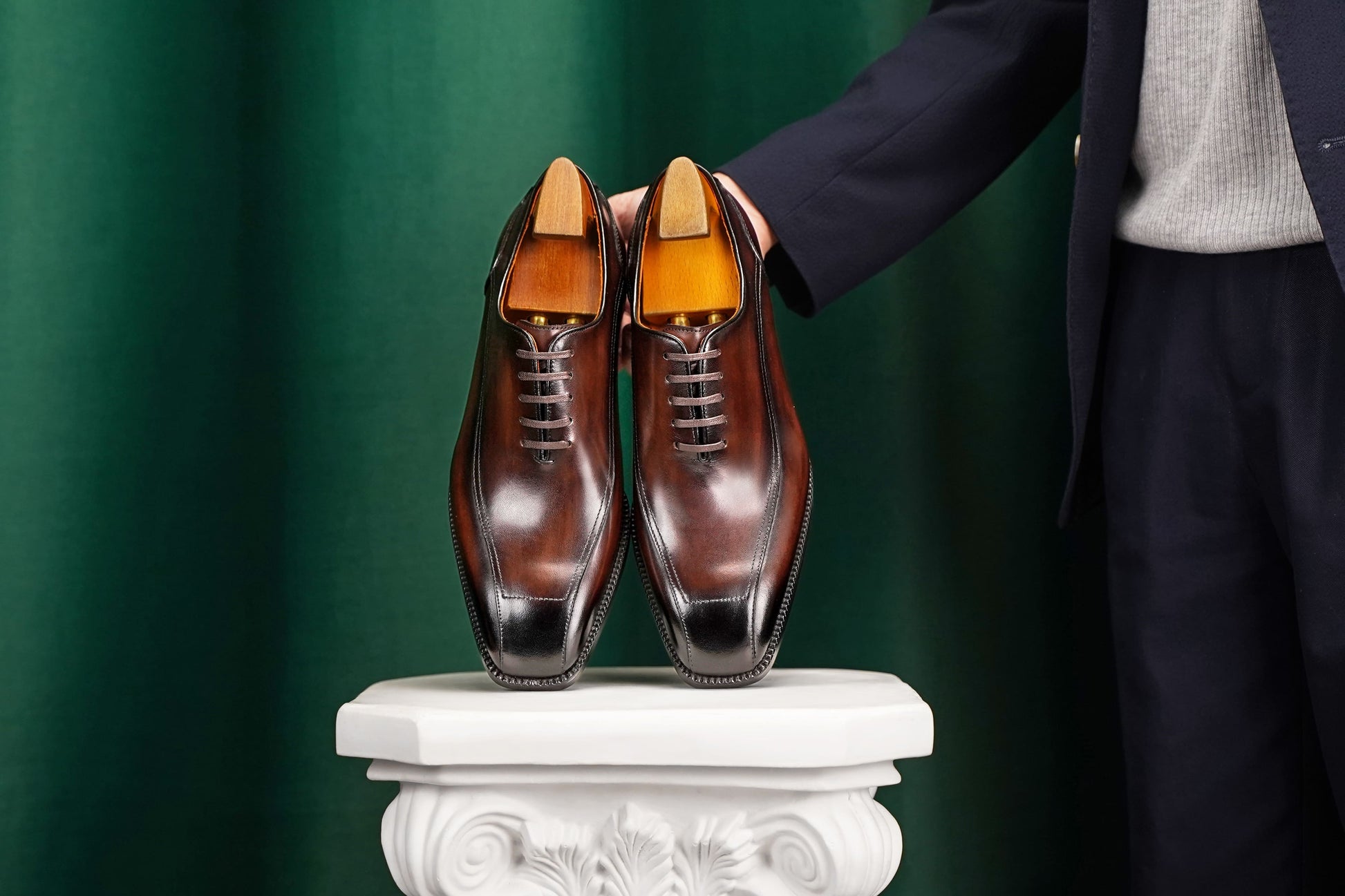 Men’s dark brown leather wholecut Oxford dress shoes with sleek lace-up design and polished formal finish.
