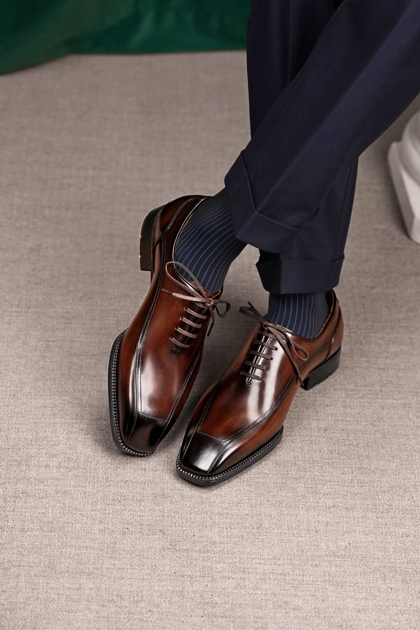 Men’s dark brown leather wholecut Oxford dress shoes with sleek lace-up design and polished formal finish.