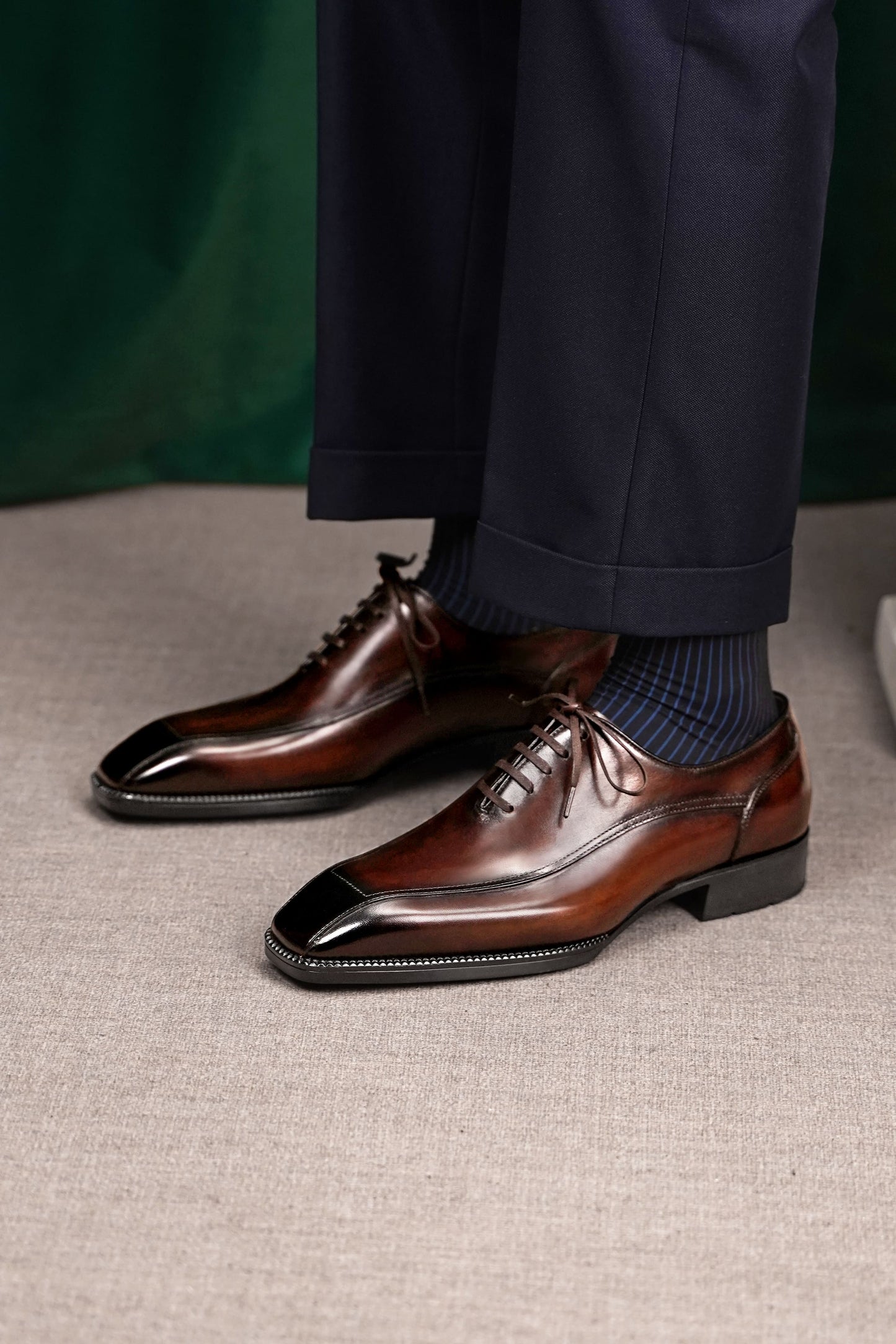 Men’s dark brown leather wholecut Oxford dress shoes with sleek lace-up design and polished formal finish.