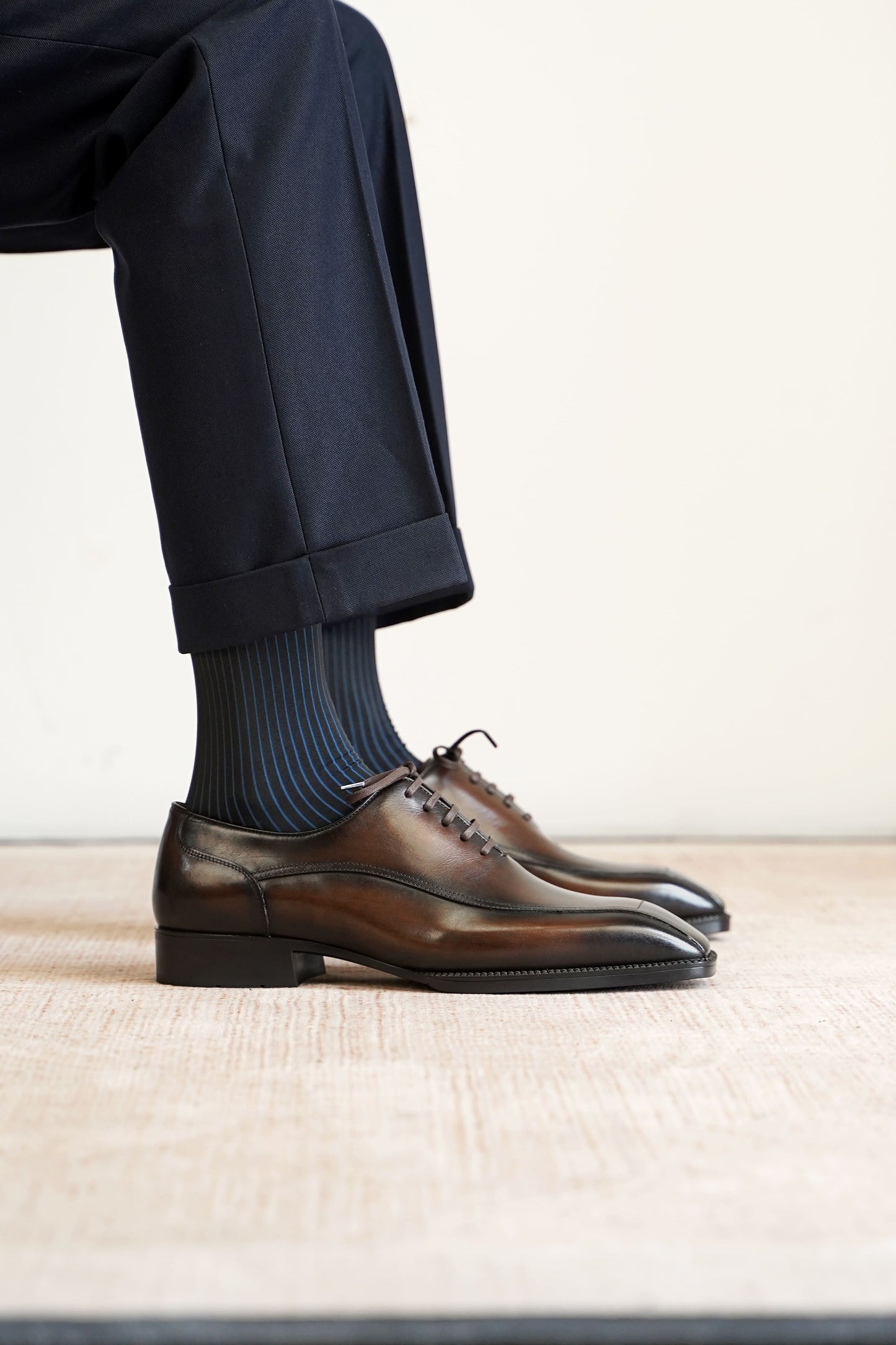 Men’s dark brown leather wholecut Oxford dress shoes with sleek lace-up design and polished formal finish.