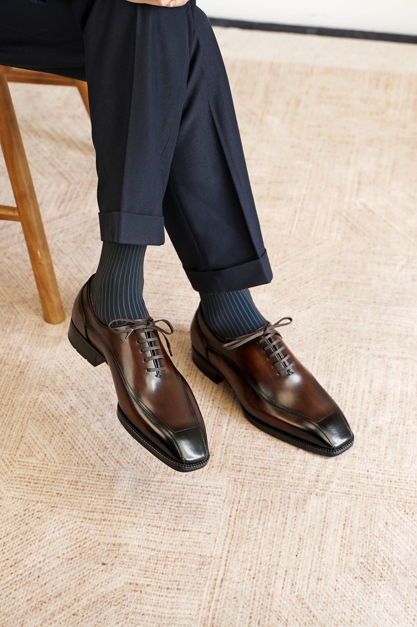 Men’s dark brown leather wholecut Oxford dress shoes with sleek lace-up design and polished formal finish.