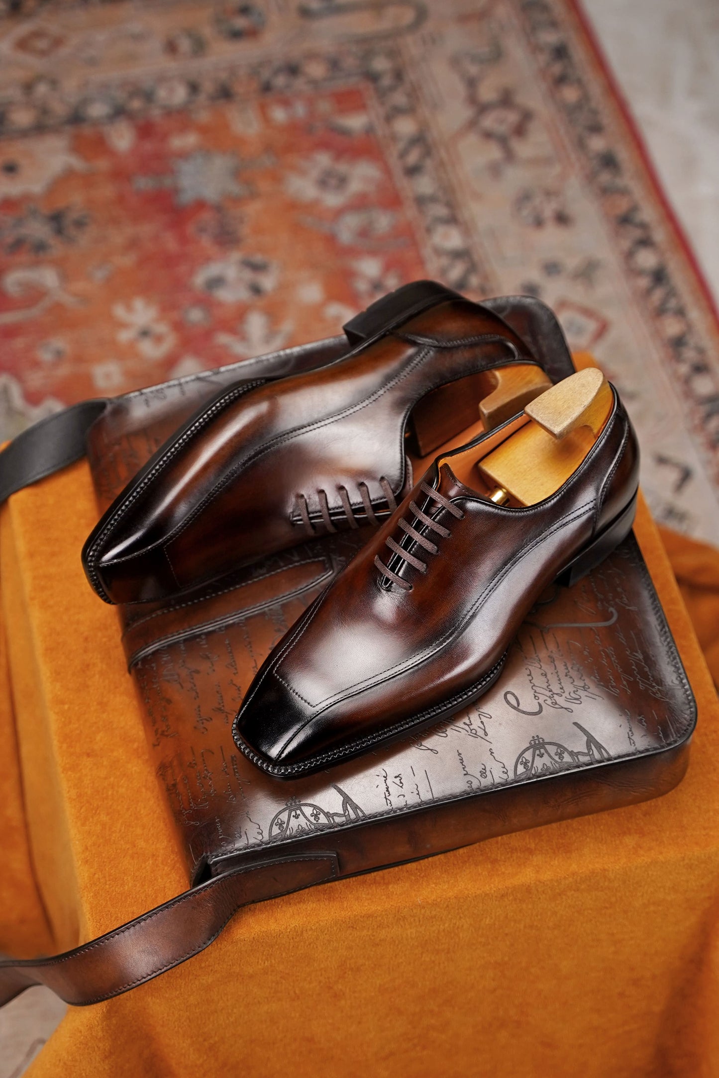 Men’s dark brown leather wholecut Oxford dress shoes with sleek lace-up design and polished formal finish.