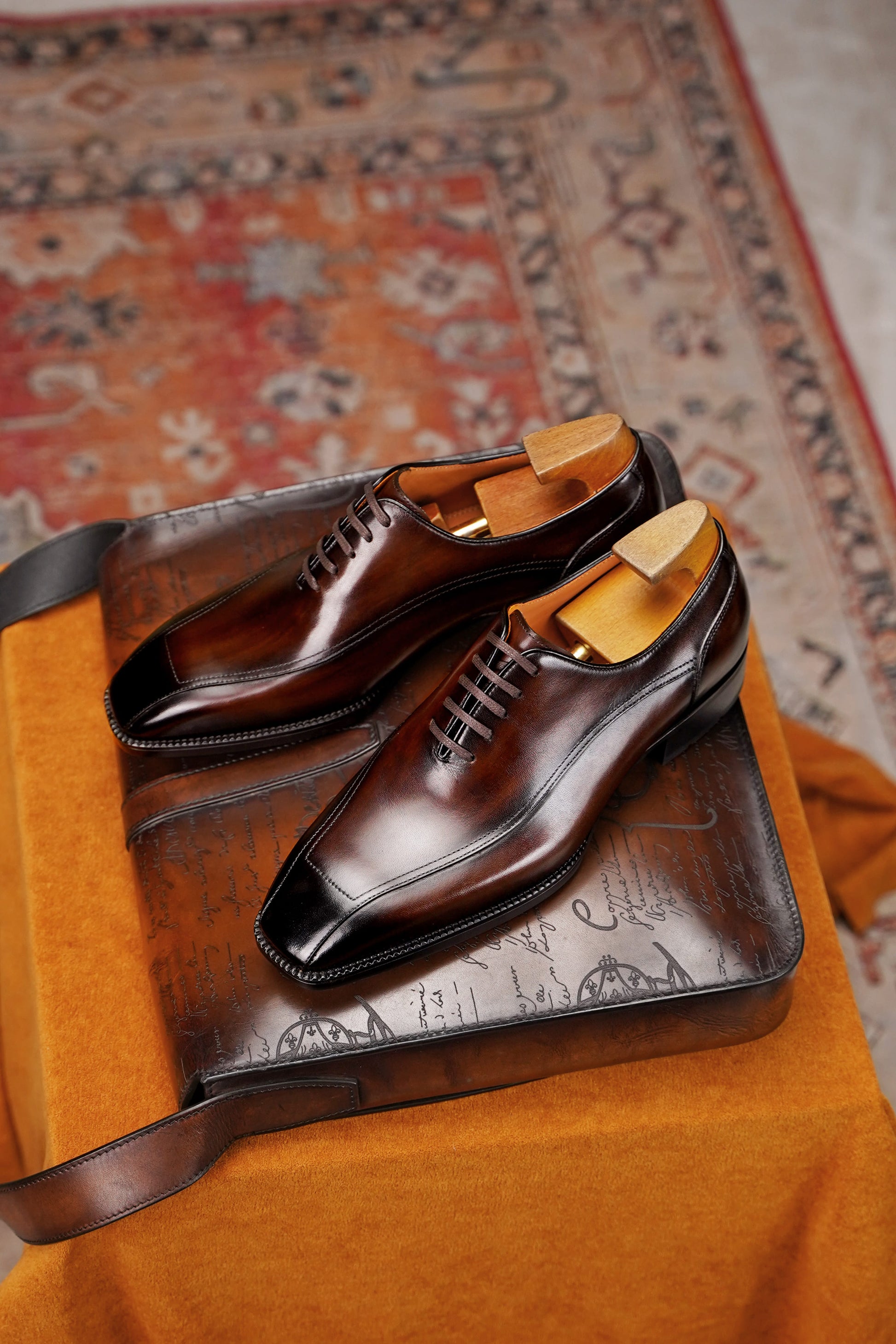 Men’s dark brown leather wholecut Oxford dress shoes with sleek lace-up design and polished formal finish.