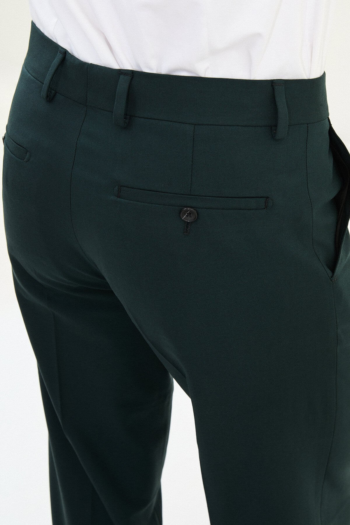 Men wearing dark grey slim-fit classic trousers, styled with formal shoes, suitable for office or business occasions.