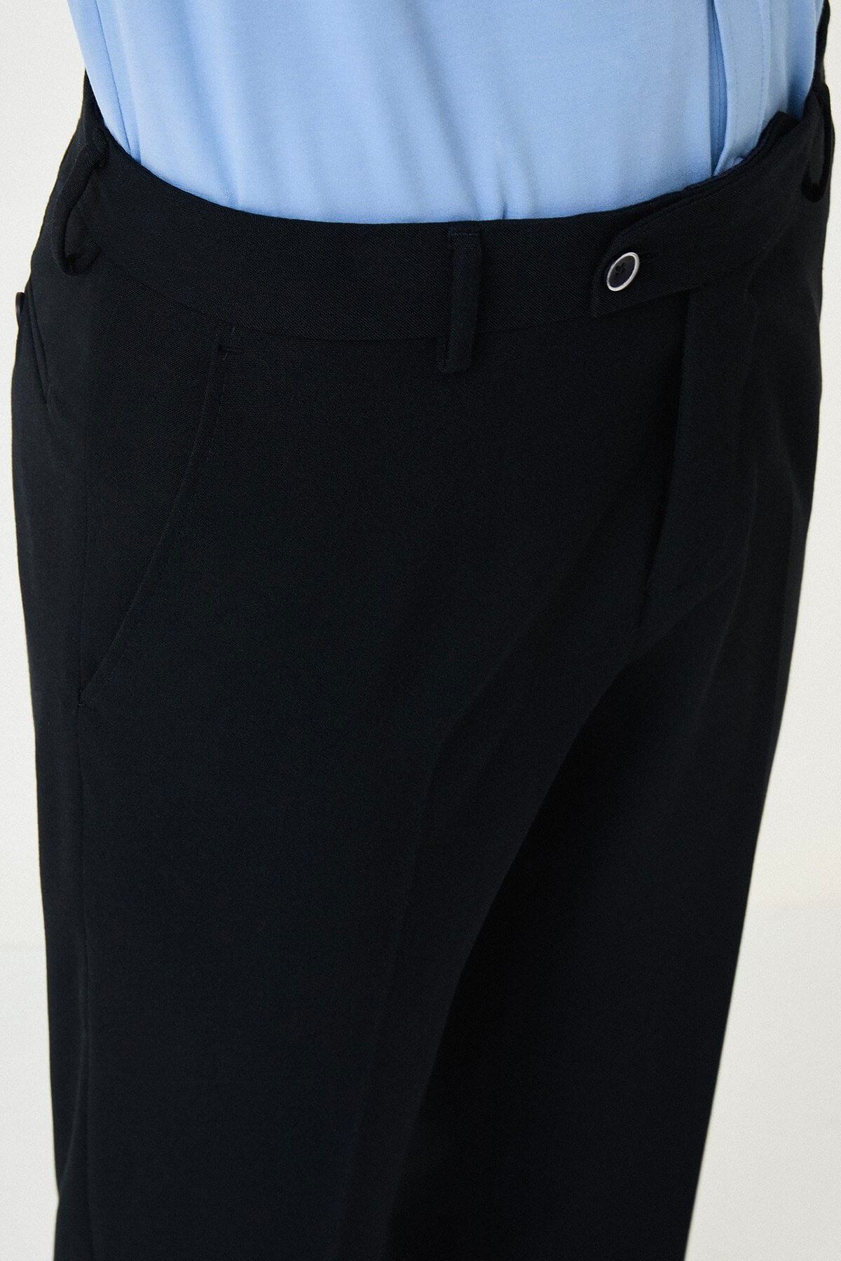 Dark Navy Blue slim-fit formal trousers with subtle pleats, styled with white sneakers, perfect for summer office.