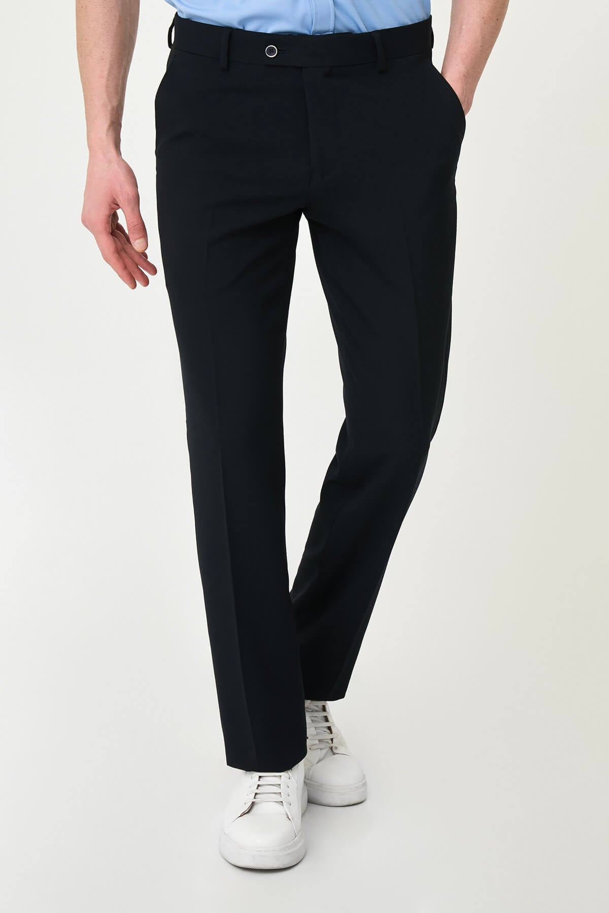 Dark Navy Blue slim-fit formal trousers with subtle pleats, styled with white sneakers, perfect for summer office.