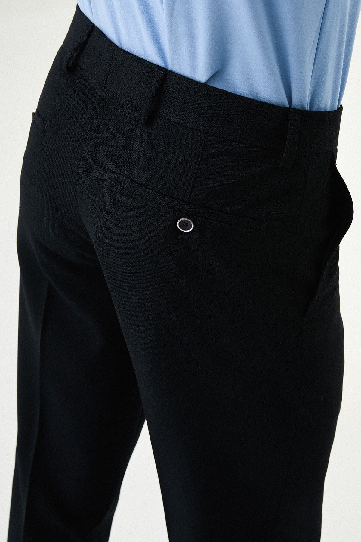 Dark Navy Blue slim-fit formal trousers with subtle pleats, styled with white sneakers, perfect for summer office.