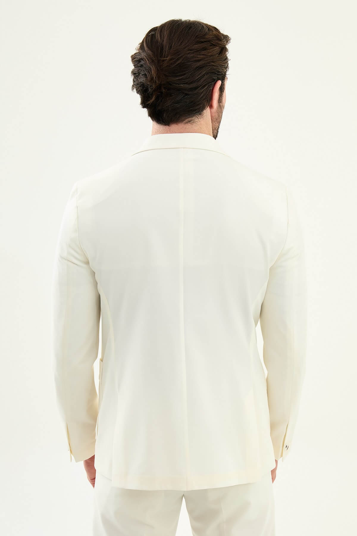 Men’s ecru slim fit blazer with a clean minimalist design and stretch fabric, styled with a black knit top for elegant smart casual and formal looks.