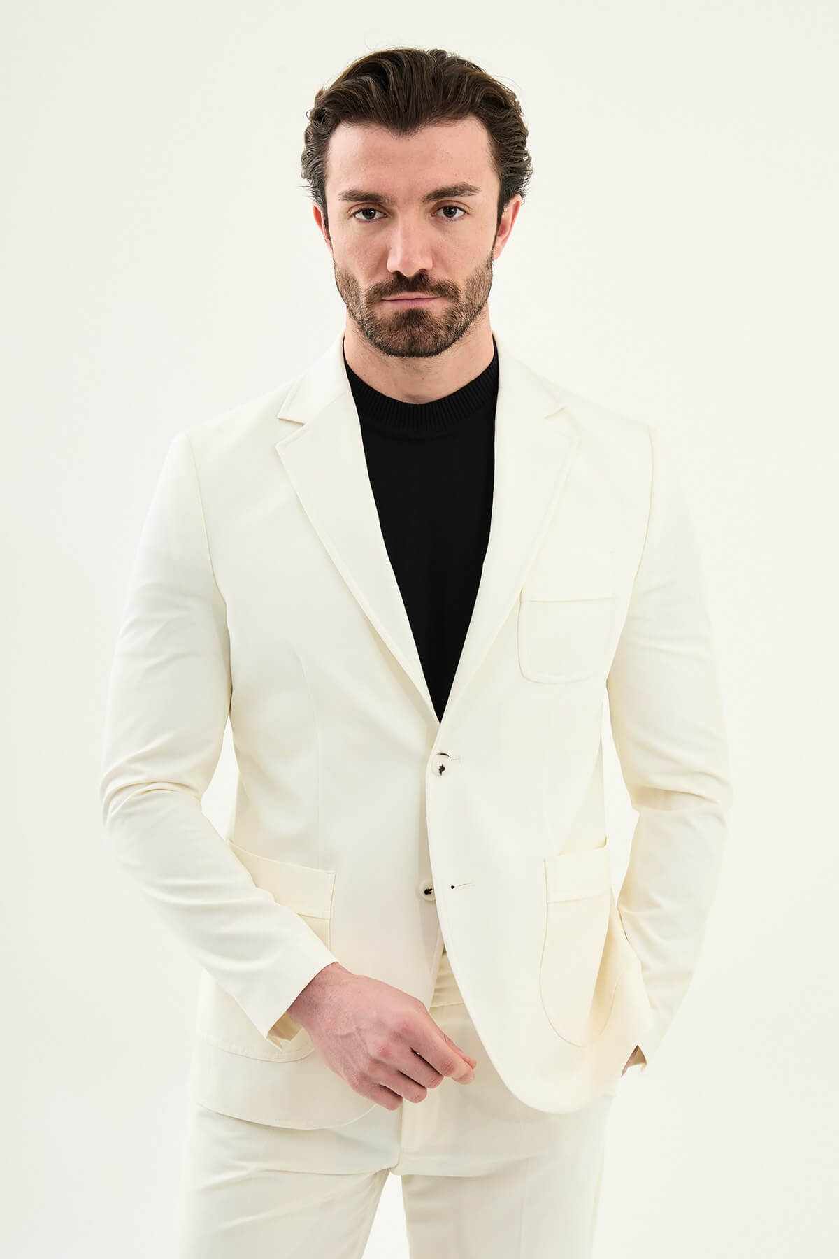 Men’s ecru slim fit blazer with a clean minimalist design and stretch fabric, styled with a black knit top for elegant smart casual and formal looks.