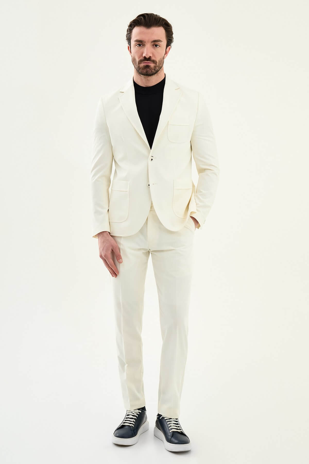 Men’s ecru slim fit blazer with a clean minimalist design and stretch fabric, styled with a black knit top for elegant smart casual and formal looks.