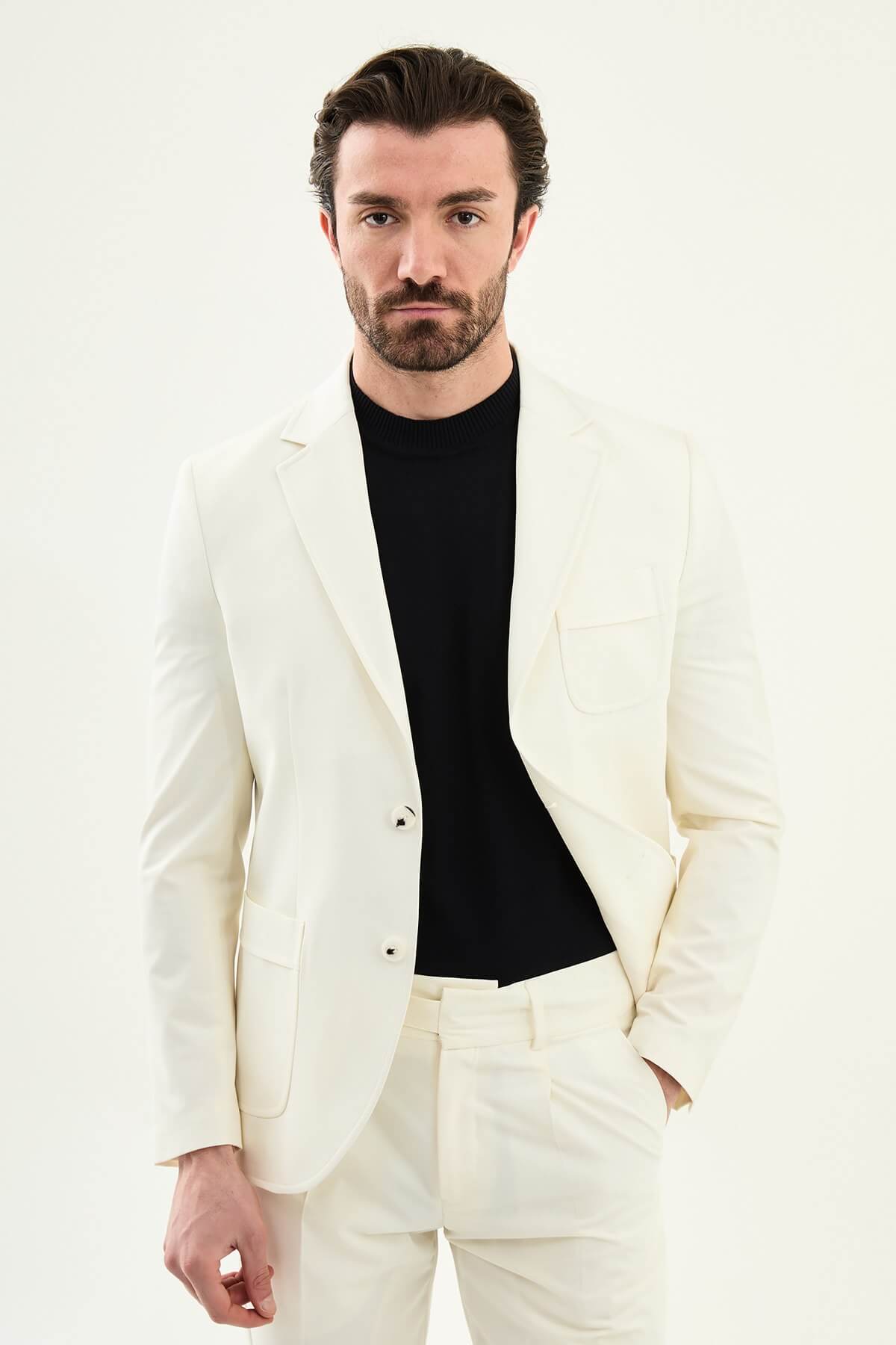 Men’s ecru slim fit blazer with a clean minimalist design and stretch fabric, styled with a black knit top for elegant smart casual and formal looks.