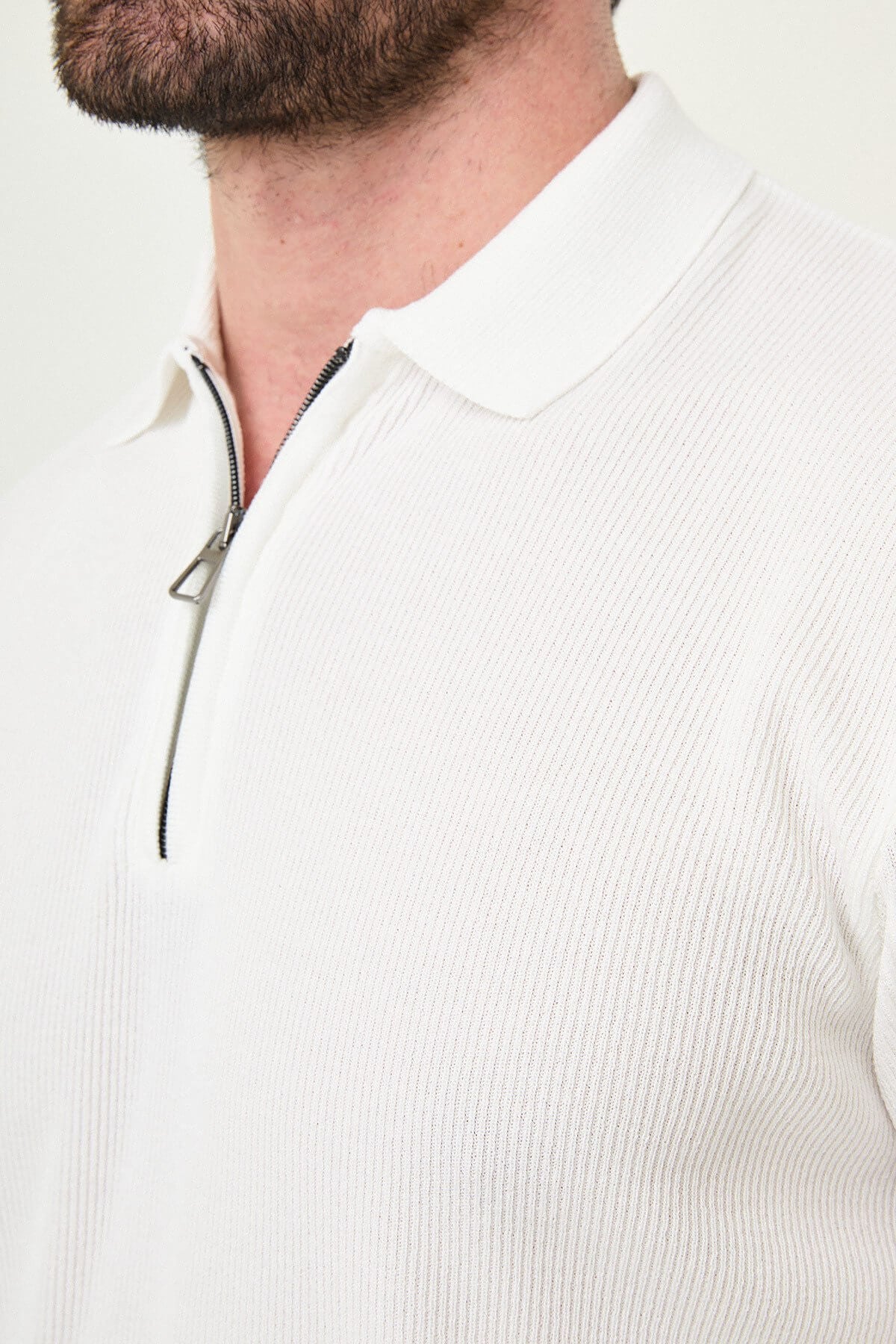 Men’s ecru slim-fit quarter-zip knit polo shirt with ribbed texture, short sleeves, classic collar, and modern luxury casual design.