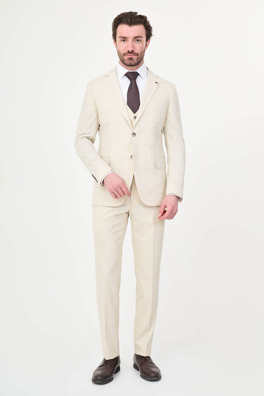 an ecru check slim-fit three-piece suit with matching waistcoat and trousers, white dress shirt, dark brown tie, and brown leather Derby shoes.