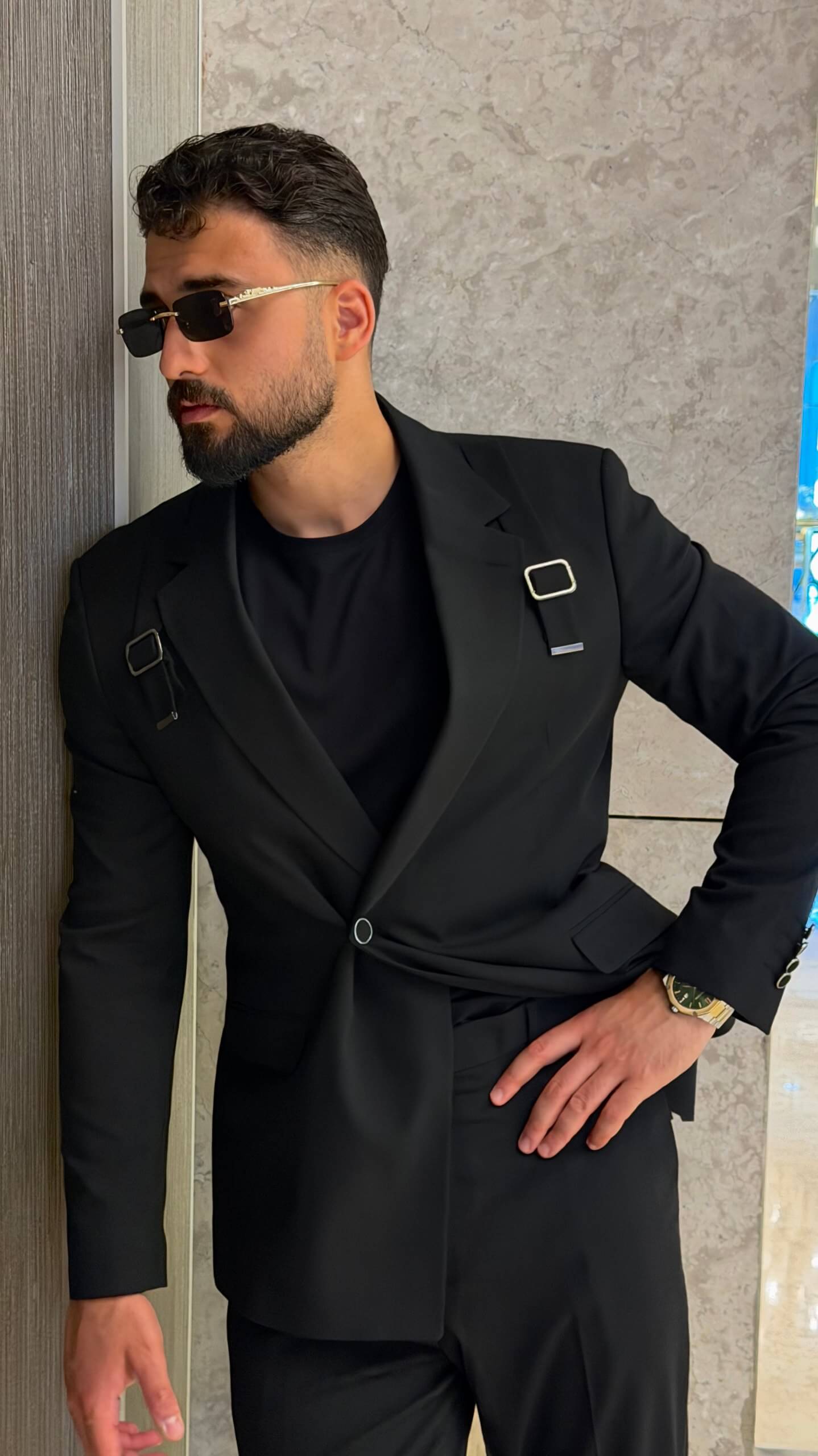 Men's black tailored fashion suit with modern strap detail styled with black T-shirt