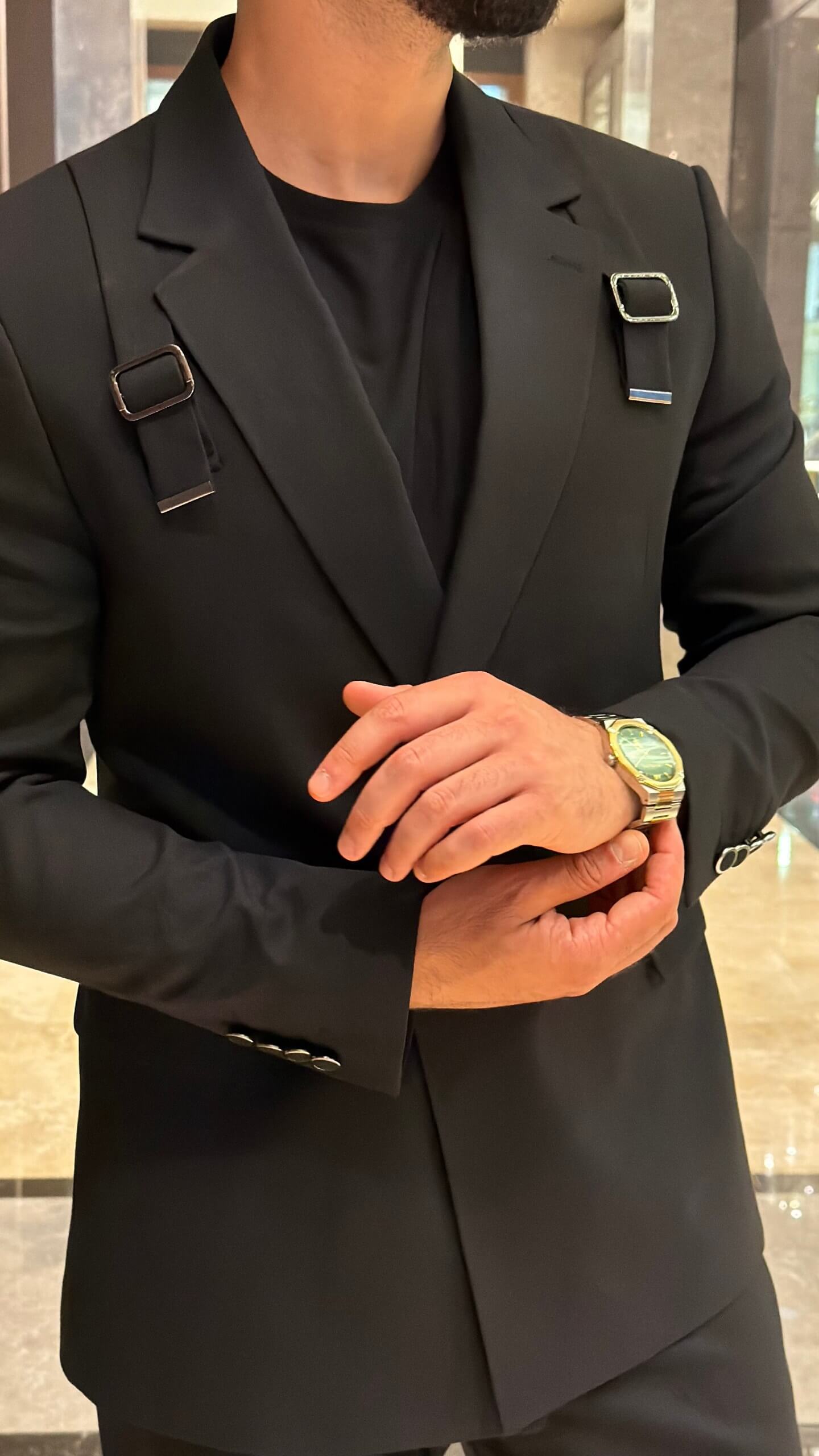 Men's black tailored fashion suit with modern strap detail styled with black T-shirt