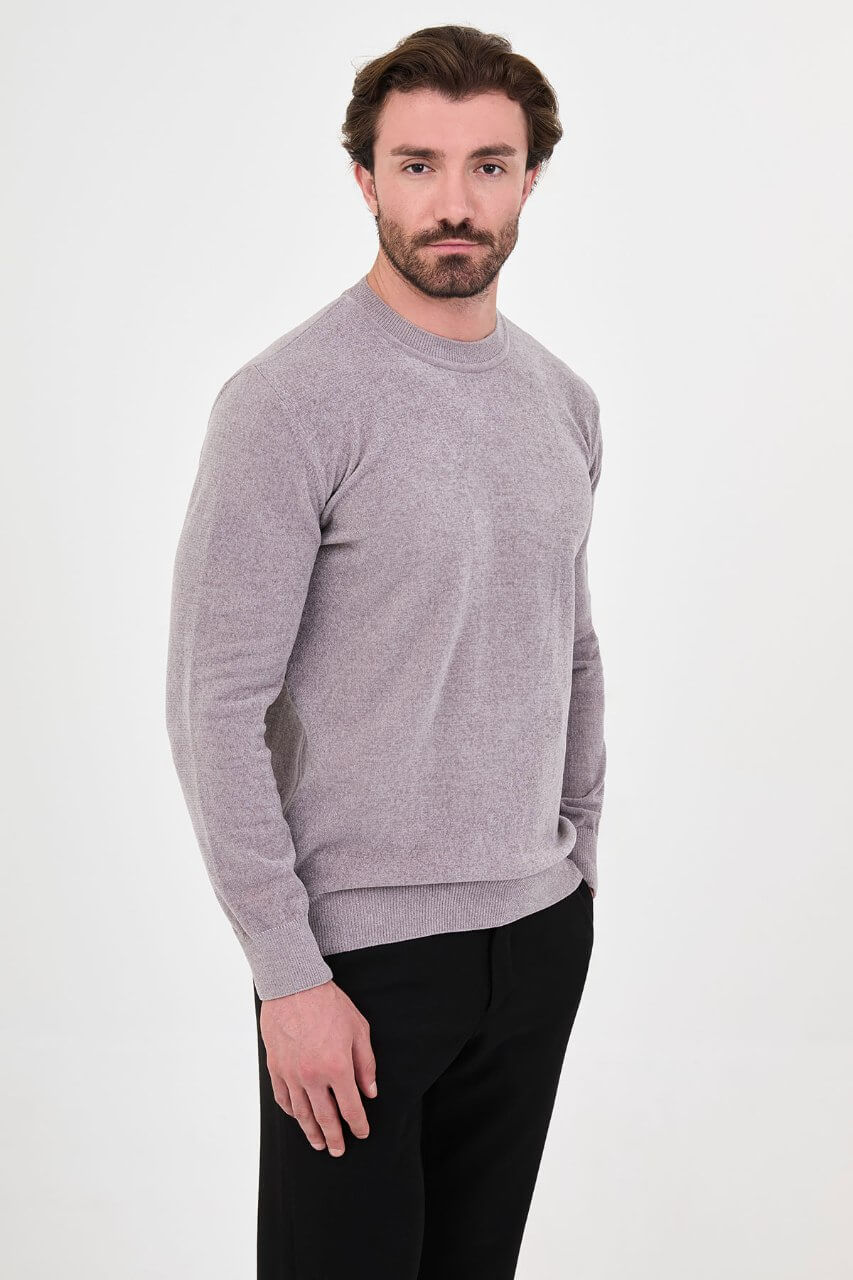 Men’s grey crew neck knit sweater in a slim fit cotton blend design styled with black trousers for a modern fall winter outfit.