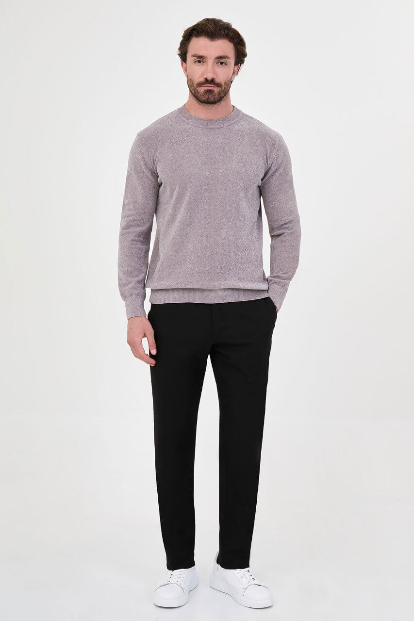 Men’s grey crew neck knit sweater in a slim fit cotton blend design styled with black trousers for a modern fall winter outfit.