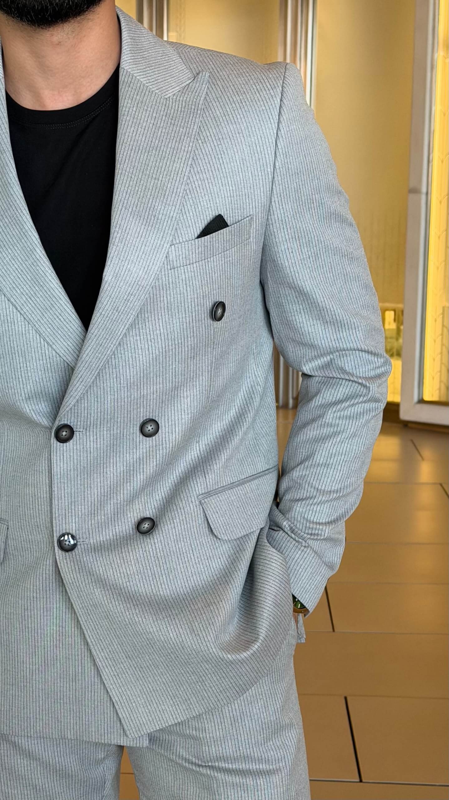Men's gray double breasted suit with tailored jacket and matching trousers