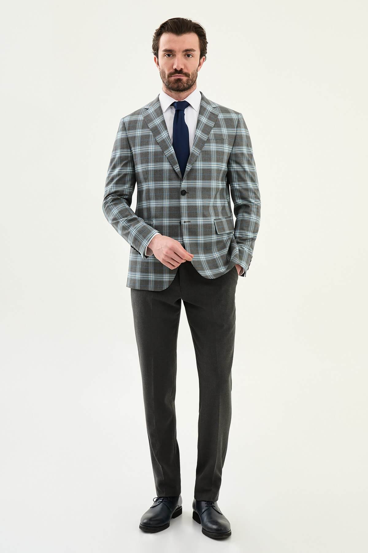 Men’s Gray Plaid Slim Fit Suit on model, paired with a navy tie.