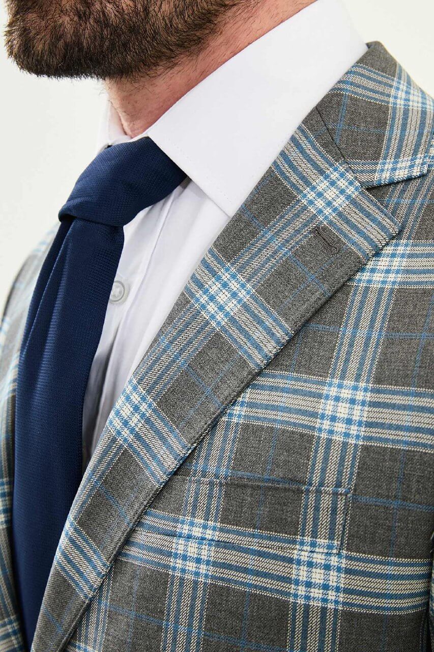 Men’s Gray Plaid Slim Fit Suit on model, paired with a navy tie.