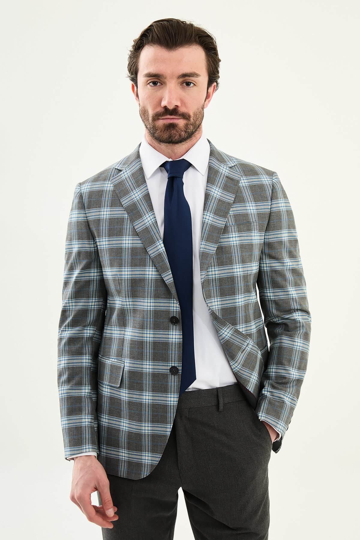 Men’s Gray Plaid Slim Fit Suit on model, paired with a navy tie.