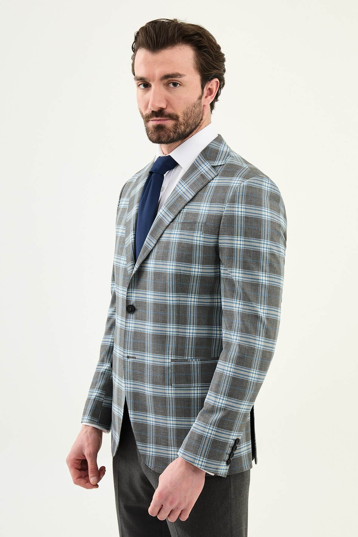 Men’s Gray Plaid Slim Fit Suit on model, paired with a navy tie.