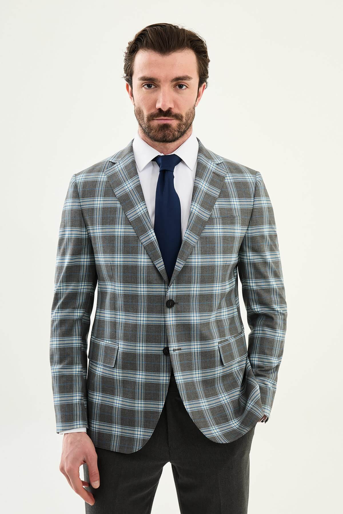 Men’s Gray Plaid Slim Fit Suit on model, paired with a navy tie.