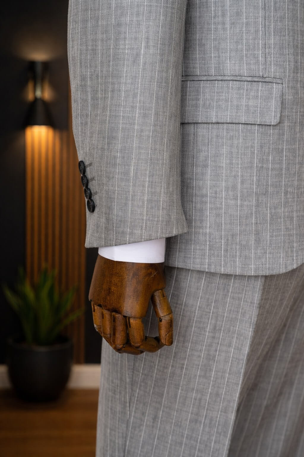 Gray pinstripe slim fit men’s suit styled with black tie and white shirt