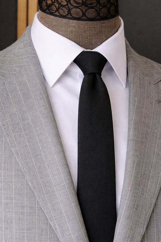Grey pinstripe suit jacket close-up showing fine vertical stripe