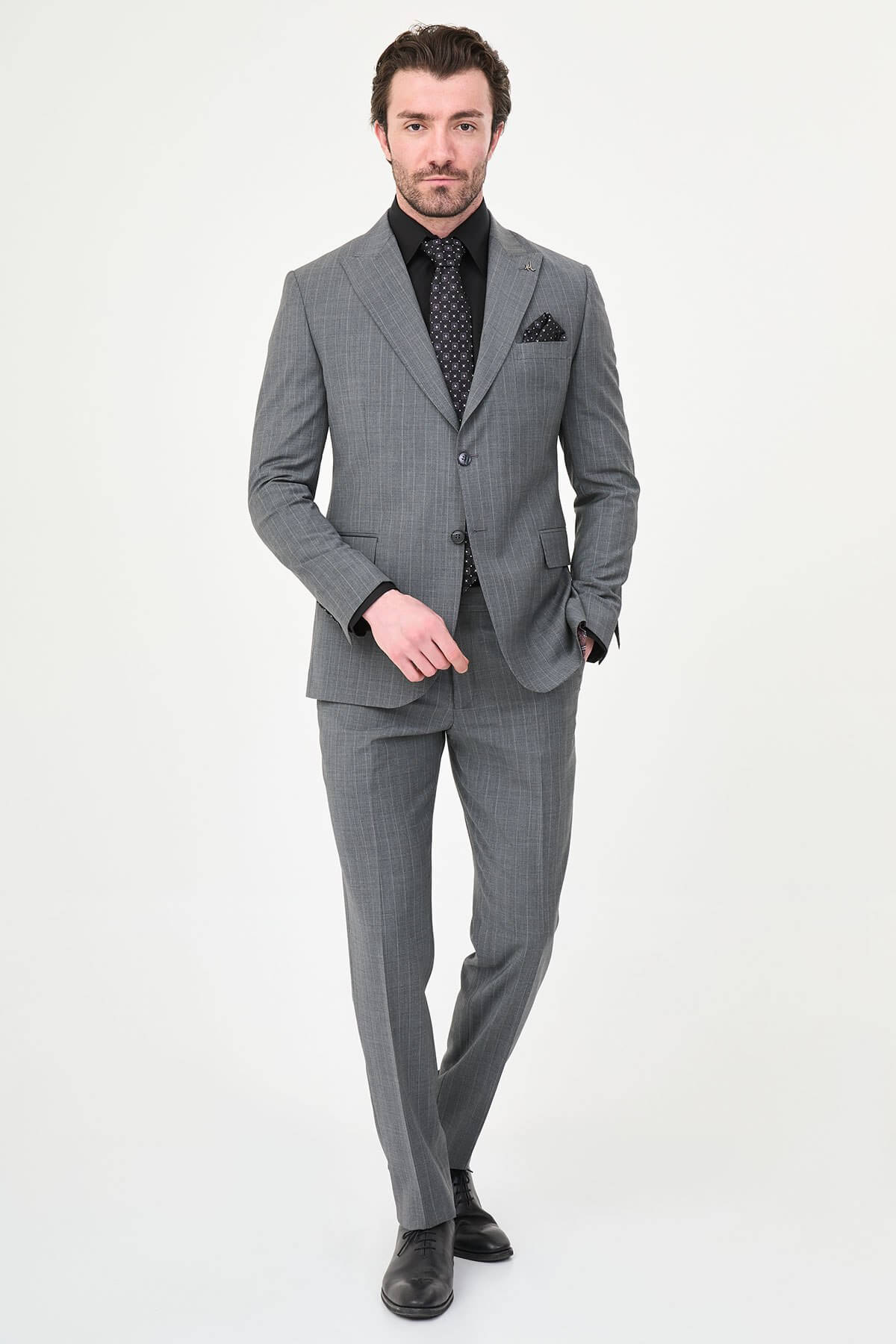 Man wearing Men’s Gray Slim-Fit Wide Collar Premium Wool Suit, styled with formal shoes and a dress shirt, ideal for summer weddings and business events.