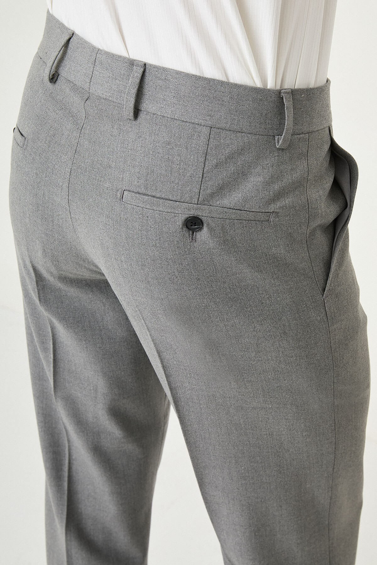 Gray slim-fit formal trousers with front pleats, styled with black or brown leather shoes, ideal for summer office and semi-formal occasions.
