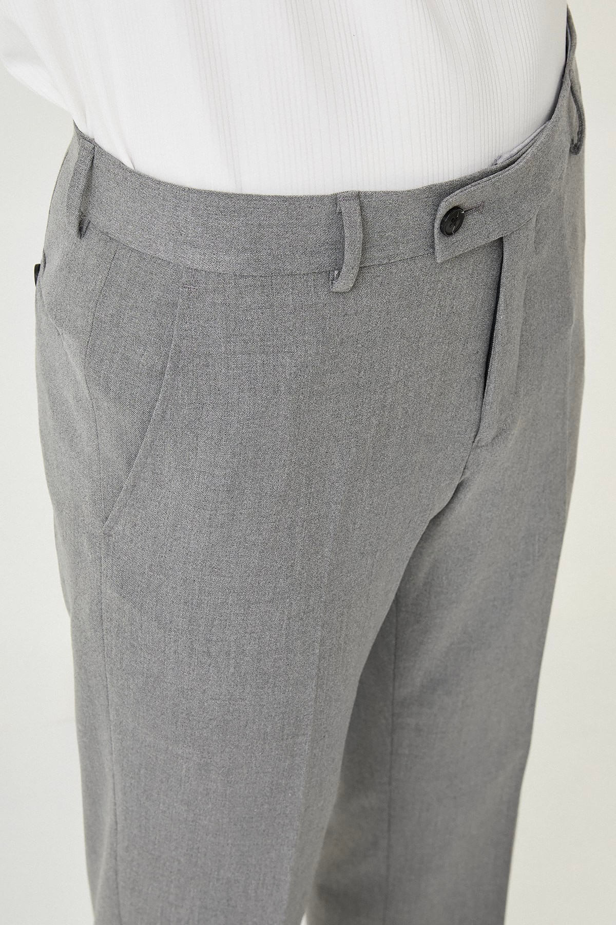 Gray slim-fit formal trousers with front pleats, styled with black or brown leather shoes, ideal for summer office and semi-formal occasions.