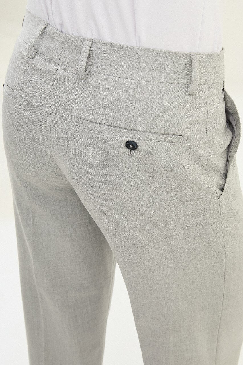 Gray slim-fit formal trousers with front pleats, styled with black leather shoes, ideal for summer office and semi-formal events.
